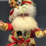A Mark Roberts Santa doll collectible wearing different Christmas items