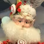 Closeup of a Mark Roberts fairy deocrated with candy and wearing a chef's hat