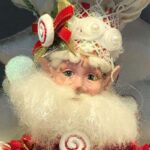 Closeup of a Mark Roberts fairy deocrated with candy and wearing a chef's hat
