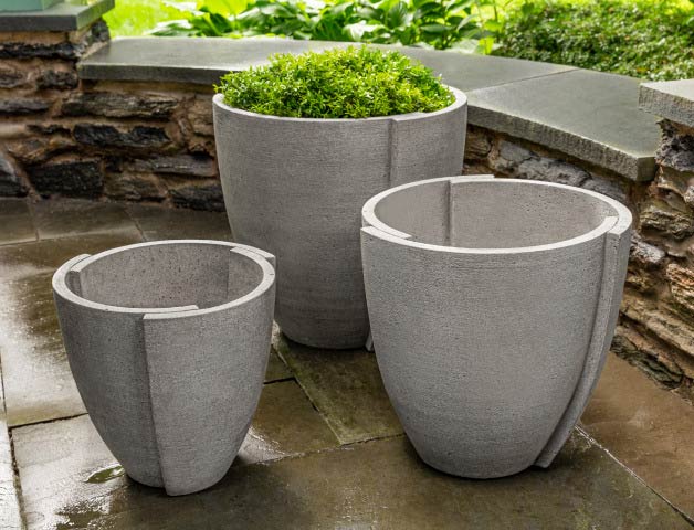 Gray, lightweight garden planters sitting on a stone porch