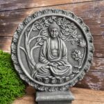 A stone decorative medallion featuring Buddha, and example of Asian garden decor