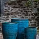 Three large ceramic planters covered with blue glaze