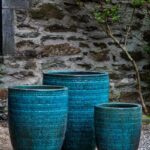 Three large ceramic planters covered with blue glaze