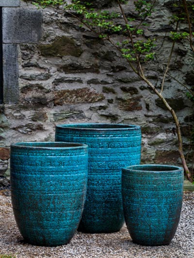 Three large ceramic planters covered with blue glaze