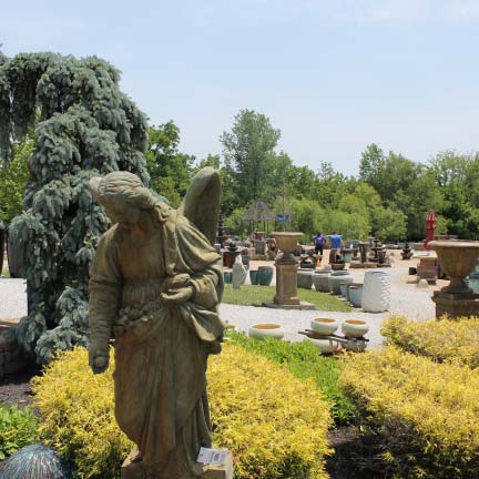 Angel statue surrounded by plants and garden decor for sale in Cincinnati, OH